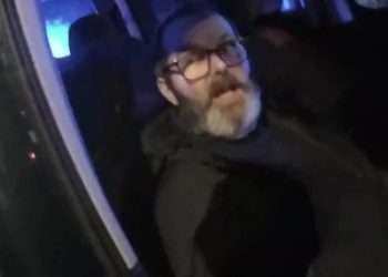 Moment thug who stabbed wife so severely the knife SNAPPED says ‘not bothered’ as he’s arrested while on run with son