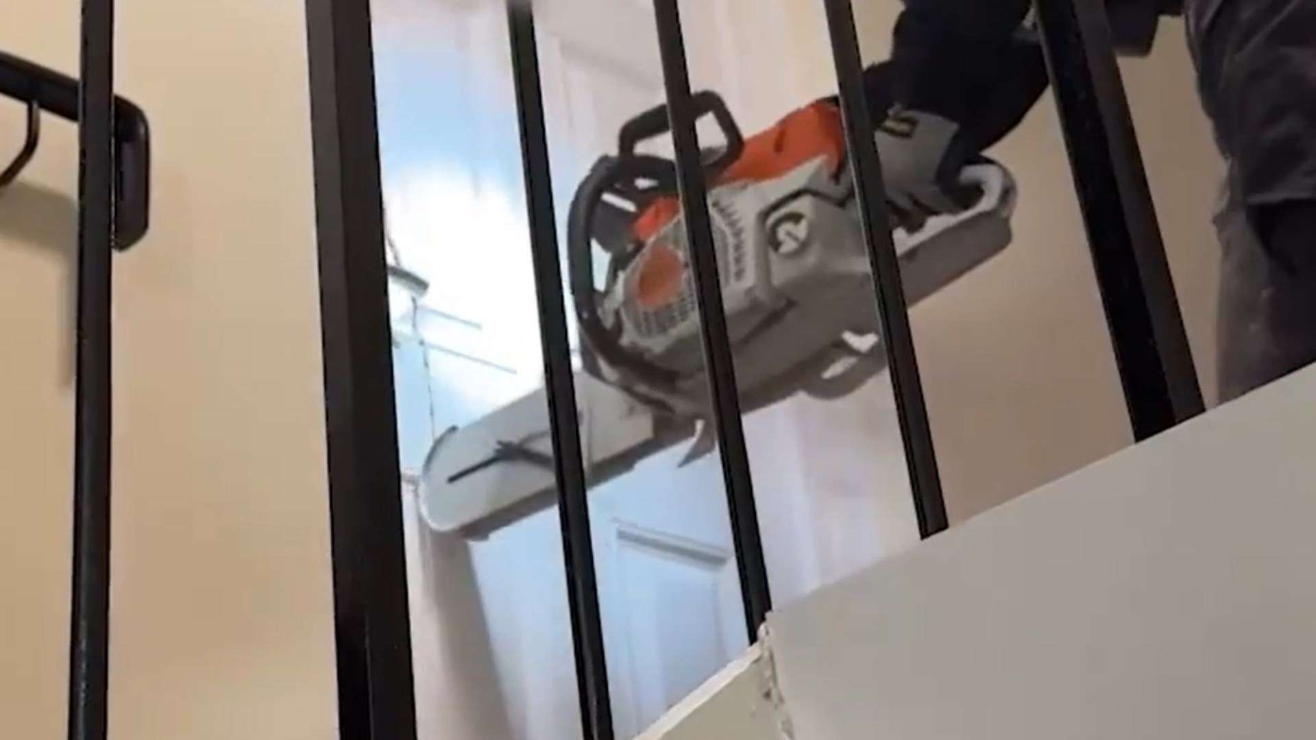 Shock moment cops blast through drug den with CHAINSAW before snaring shirtless suspect while he slept