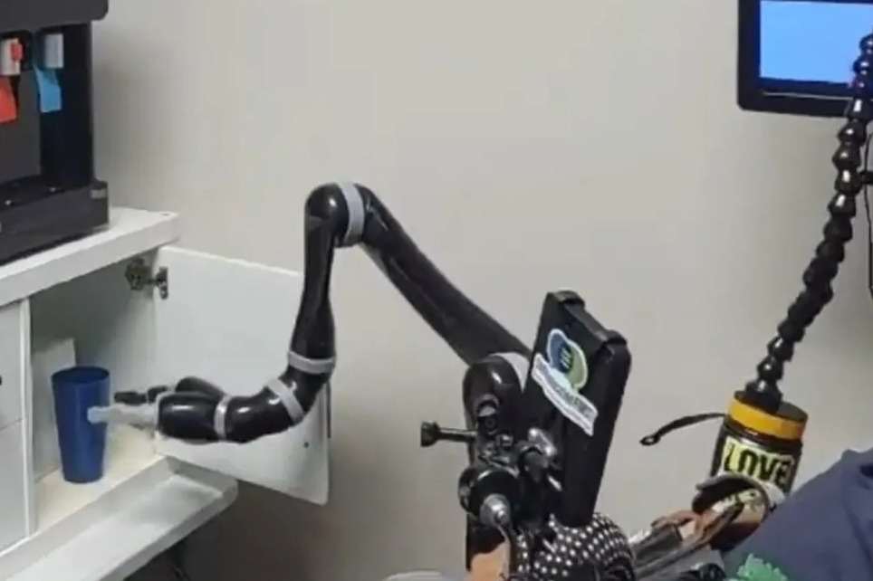 Remarkable video shows paralysed man control a robotic arm using only his MIND in groundbreaking record