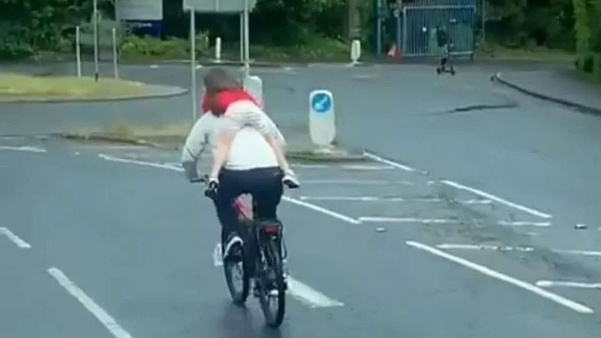Shocking moment cyclist tears through traffic with child clinging to back – before riding WRONG way through roundabout
