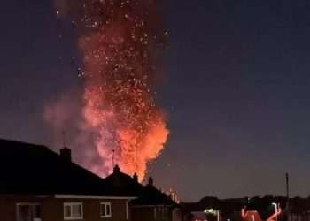 Huge blaze rises over residential street with plumes of smoke seen for miles as firefighters battle fire