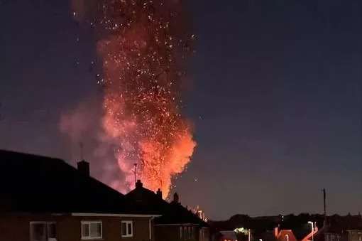 Huge blaze rises over residential street with plumes of smoke seen for miles as firefighters battle fire