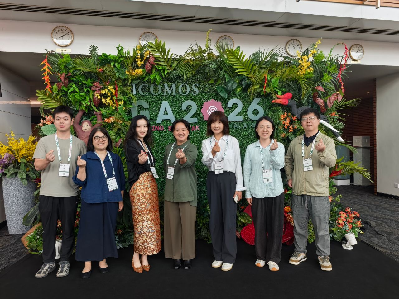 Six young scholars from Sichuan pose with Dr. Ai Tee Goh (fourth from left), convener of the 2026 ICOMOS General Assembly Scientific Symposium